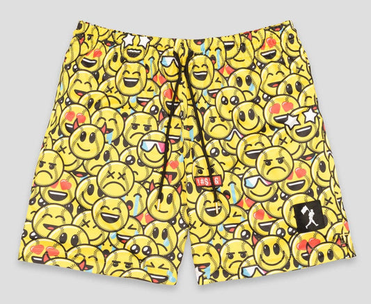 Yellow swim shorts with emoji pattern on a gray background