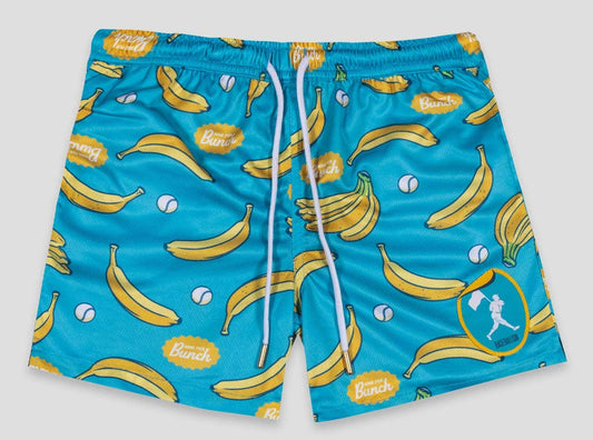 Blue swim shorts with banana pattern on a gray background